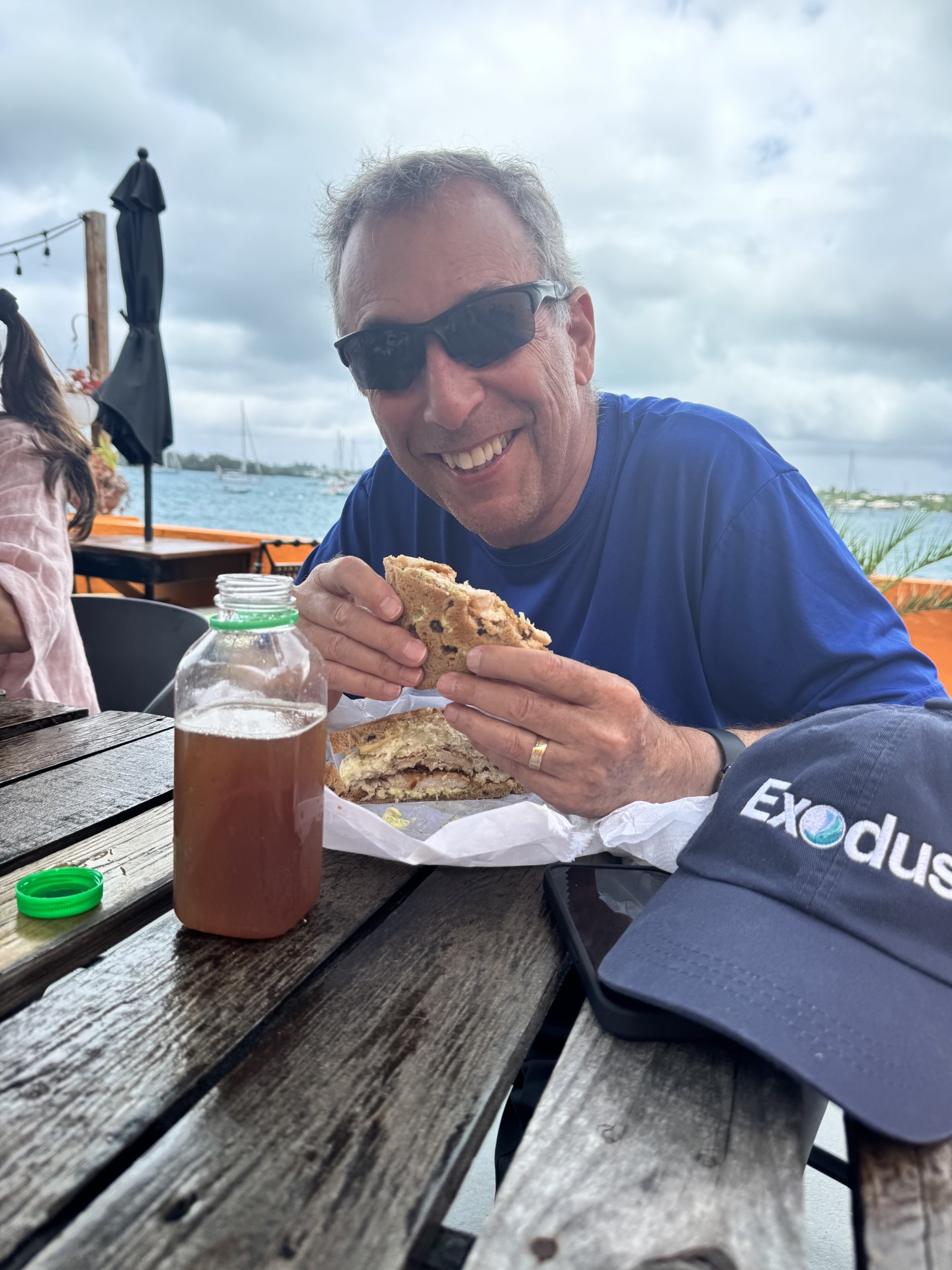 Man enjoying a traditional Bermuda fish sandwich